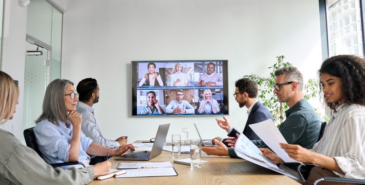 Business professionals collaborating through a virtual meeting during COVID-19 workplace changes.